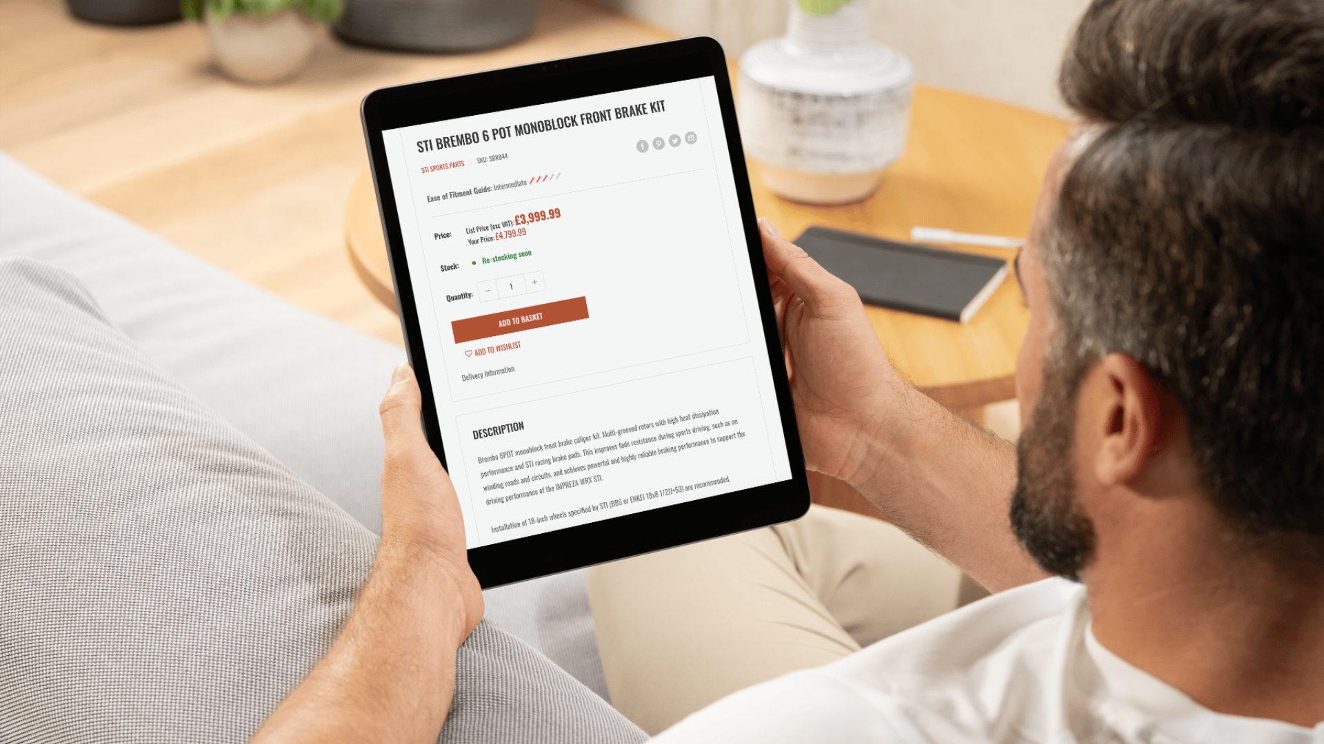 Where to show stock messages for your eCommerce site, as shown by a business savvy man holding a tablet showing stock availability of his desired item, online